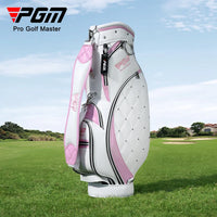 Sac de golf tour femme – coloris blanc et rose posé sur l'herbe